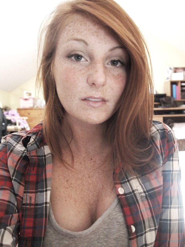 Woman with freckles in plaid shirt