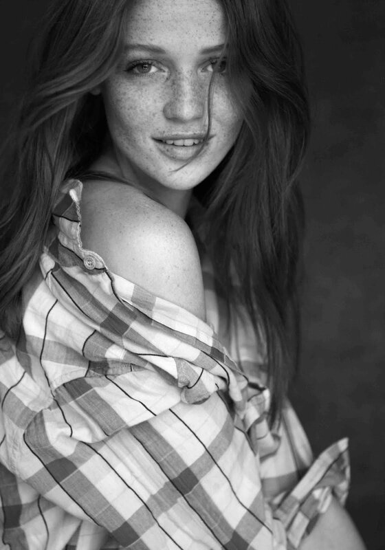 woman with freckles in plaid shirt