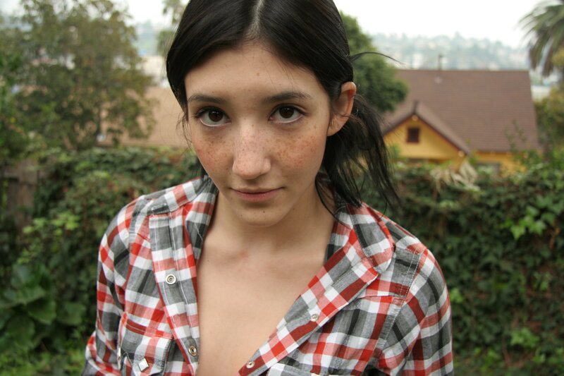 woman with freckles in plaid shirt