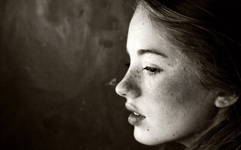 woman with freckles in profile