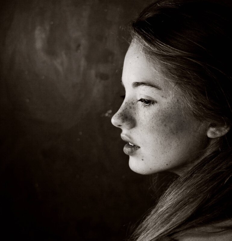 woman with freckles in profile