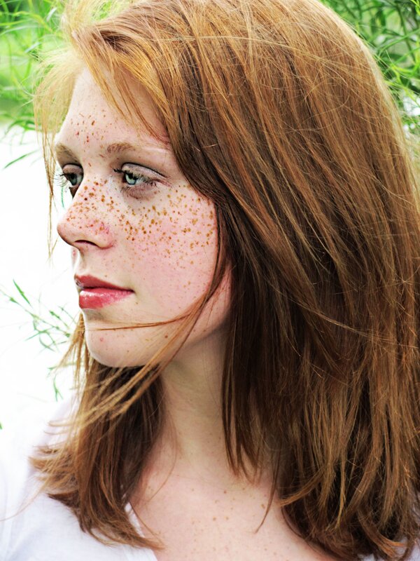 woman with freckles in profile