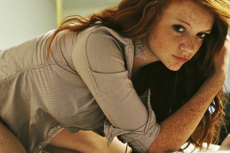 woman with freckles in striped shirt