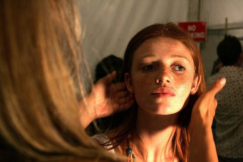 woman with freckles in warm light