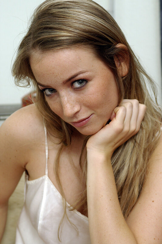 woman with freckles in white top
