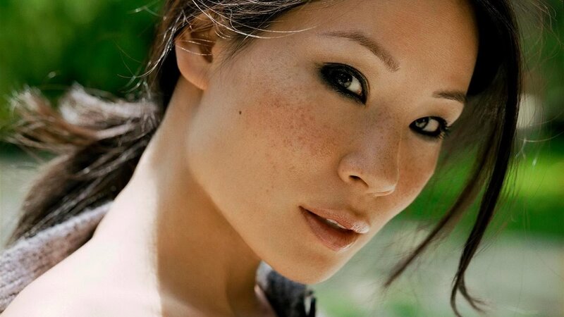 woman with freckles looking at camera