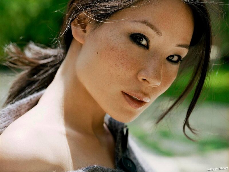 woman with freckles looking at camera