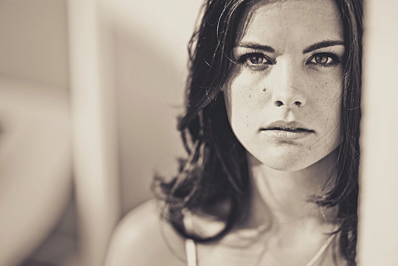 woman with freckles looking at camera