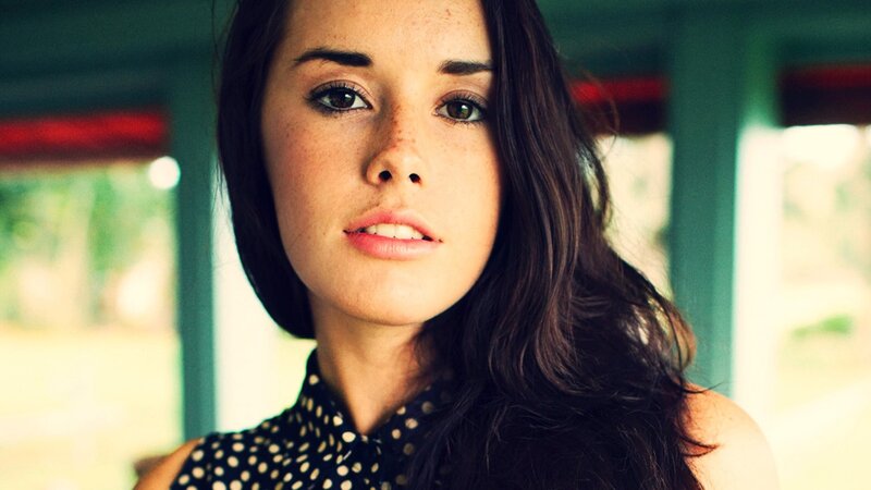 woman with freckles looking at camera