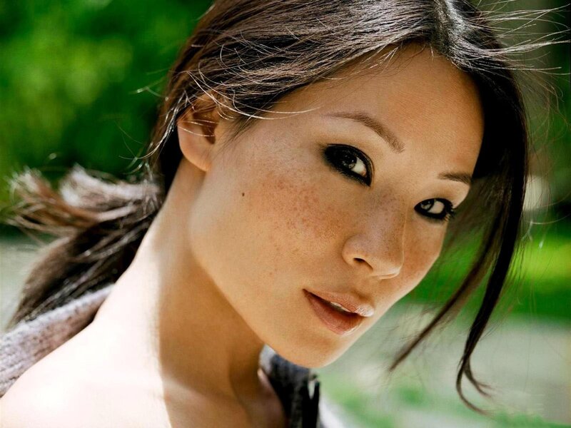 woman with freckles looking at camera
