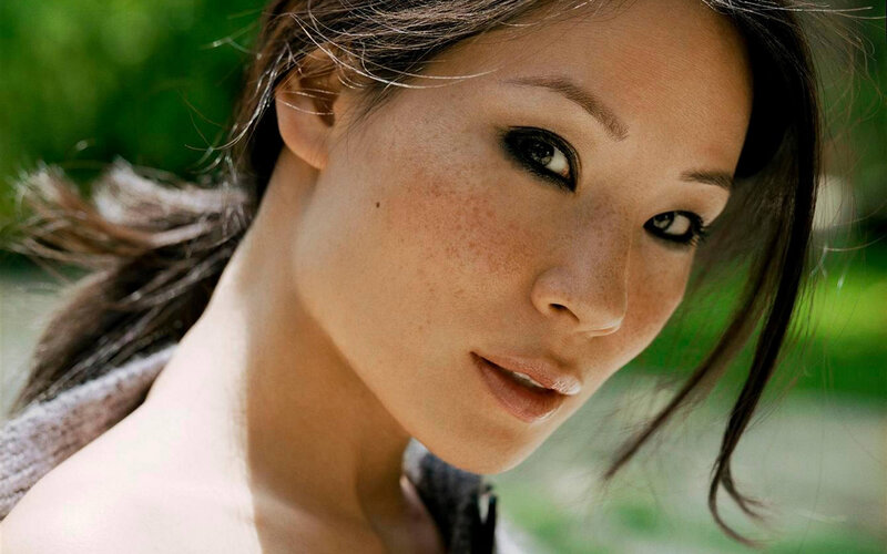 woman with freckles looking at camera