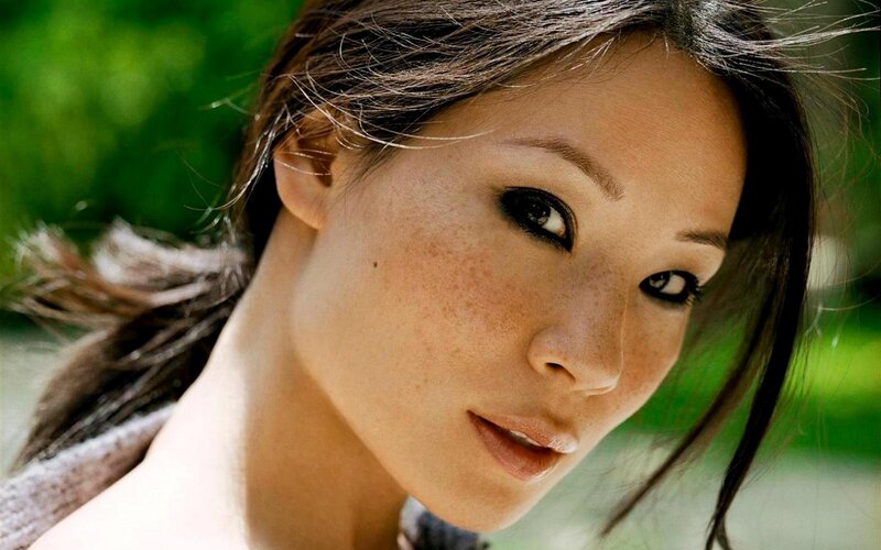 woman with freckles looking at camera
