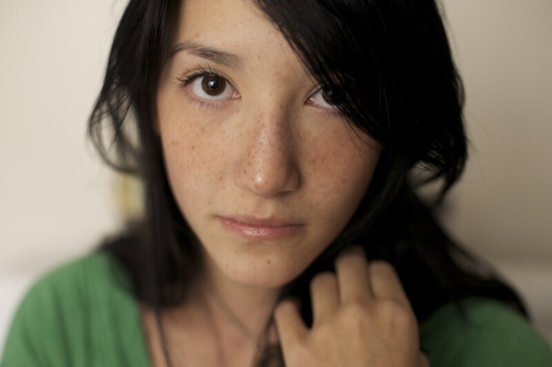 woman with freckles looking at camera
