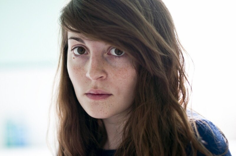 woman with freckles looking at camera