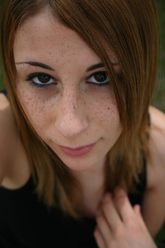 woman with freckles looking at camera