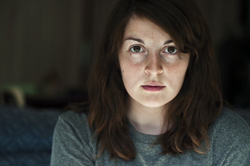woman with freckles looking at camera