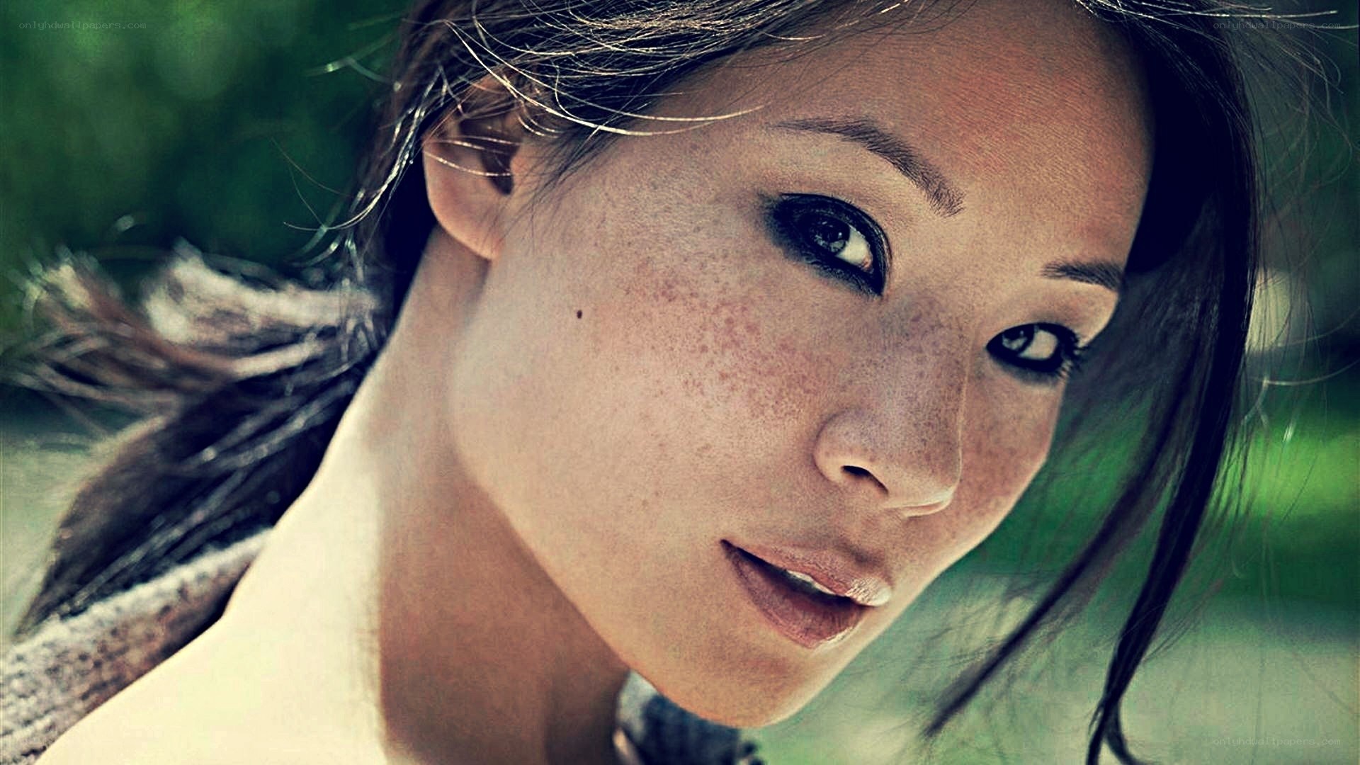 woman with freckles looking at camera