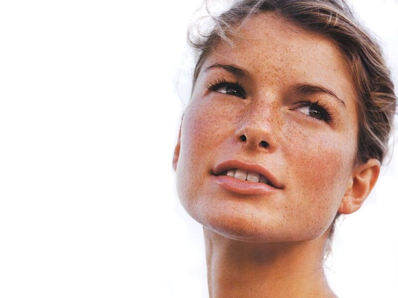 woman with freckles looking up