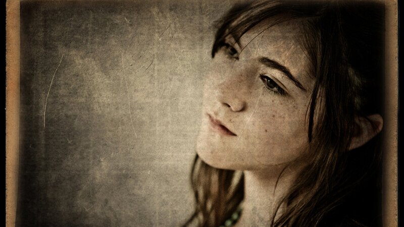 woman with freckles looking up