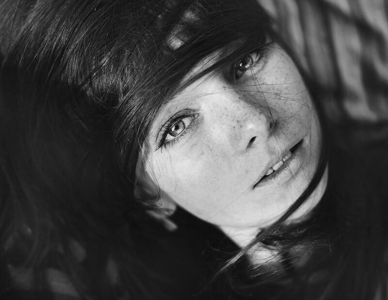 woman with freckles looking up