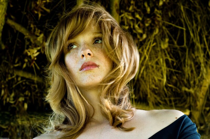 woman with freckles looking up