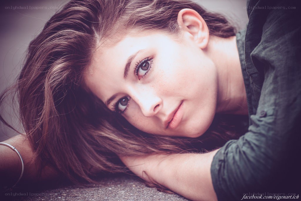 woman with freckles lying down