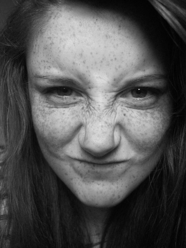 woman with freckles making a face