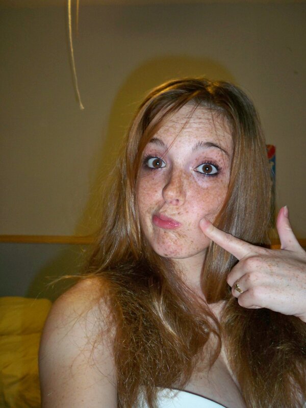 woman with freckles making a face