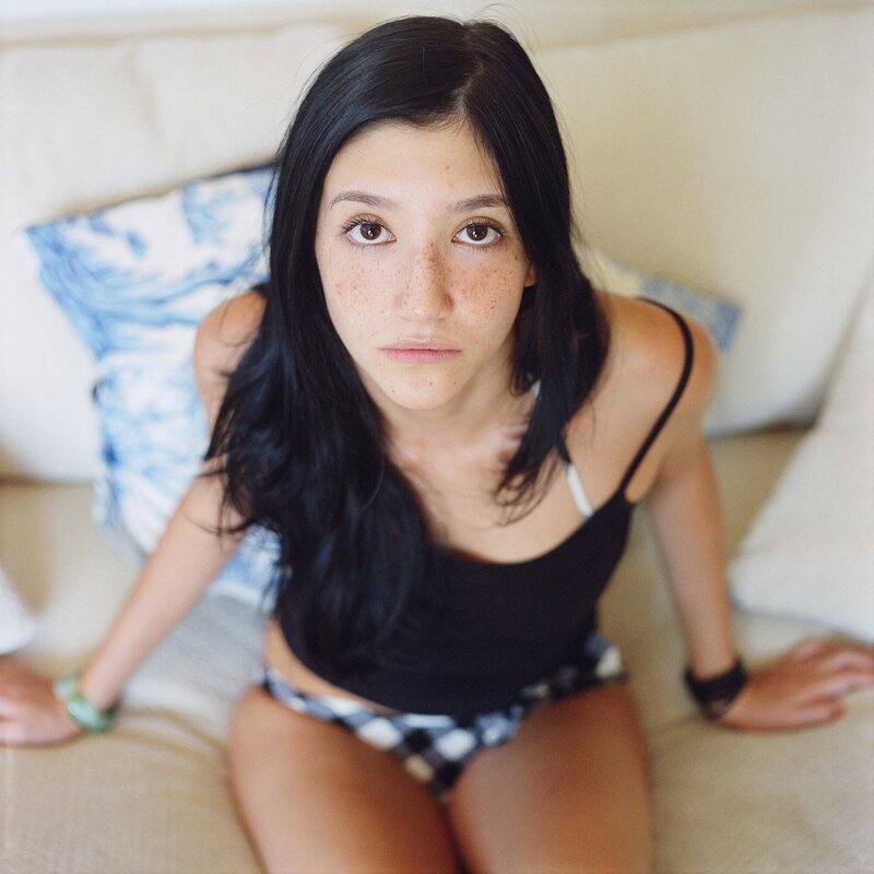 woman with freckles on a couch