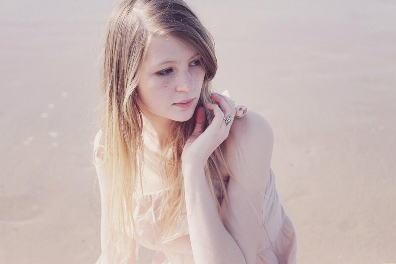 woman with freckles on beach