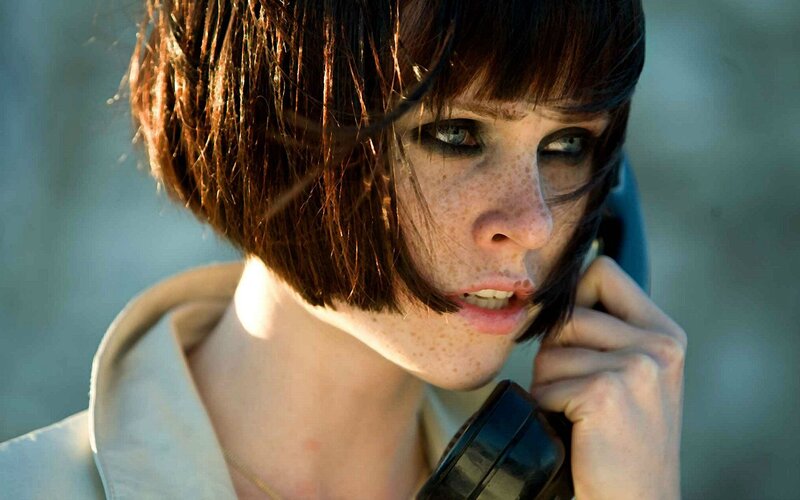 woman with freckles on phone