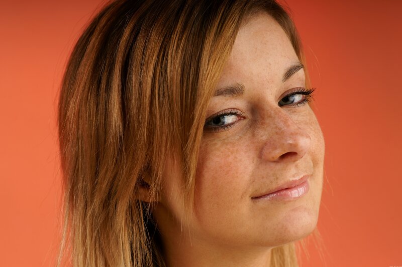 woman with freckles smiling
