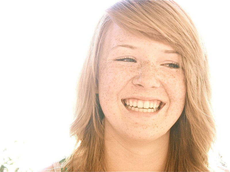 woman with freckles smiling