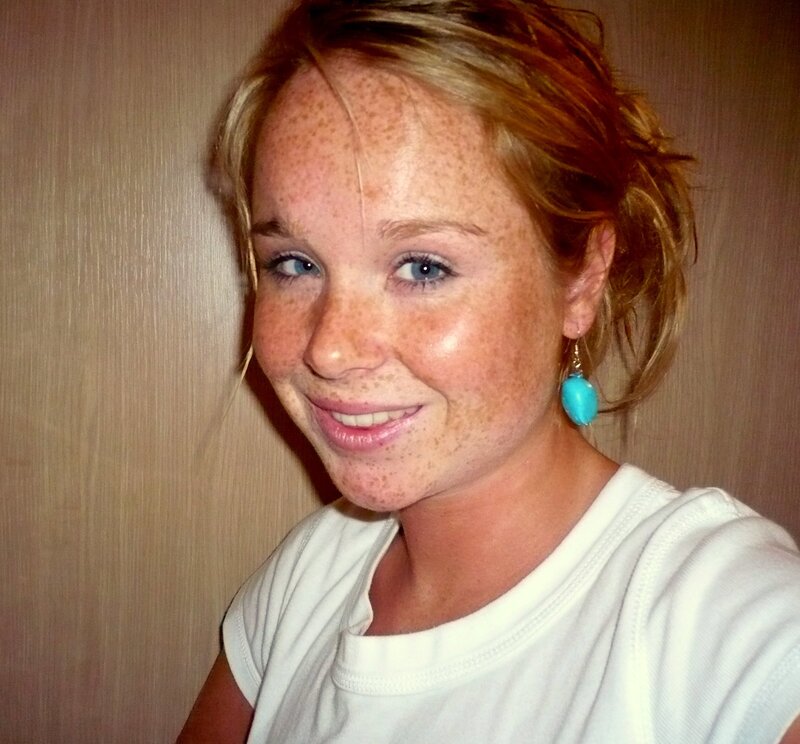 woman with freckles smiling