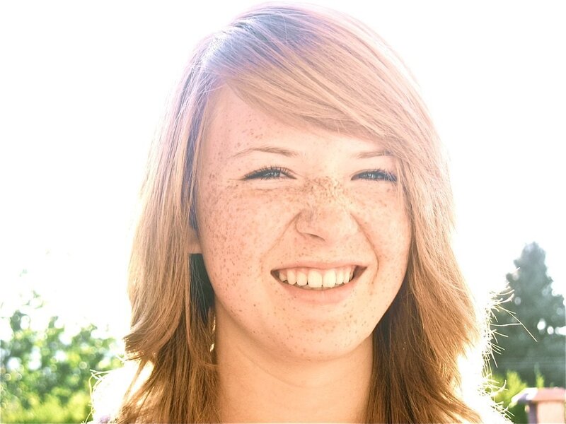 woman with freckles smiling