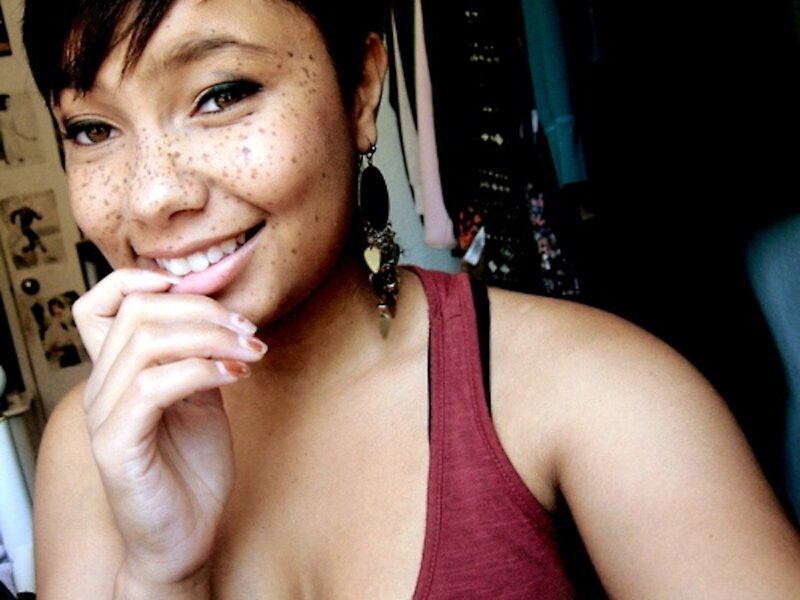 woman with freckles smiling