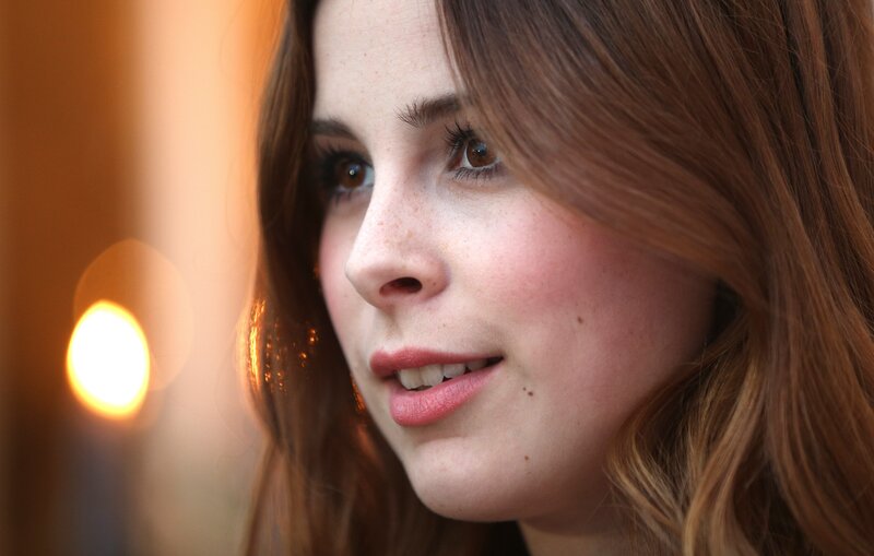 woman with freckles smiling