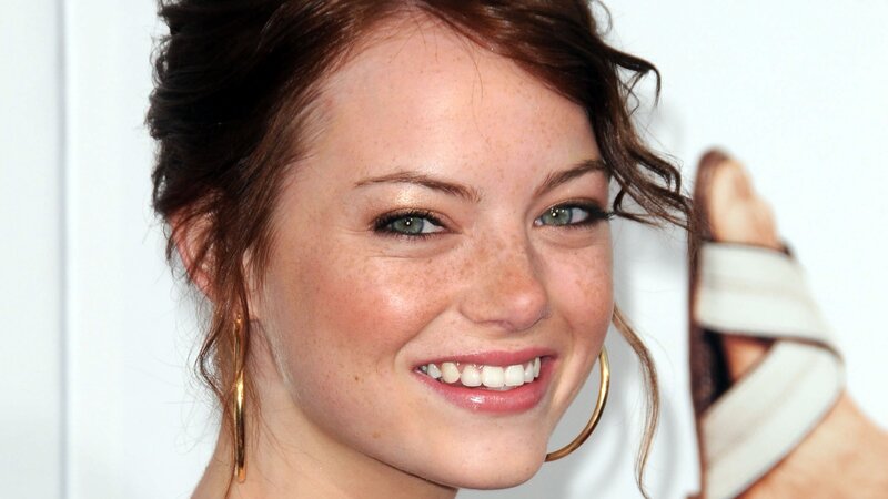 woman with freckles smiling