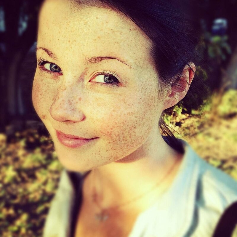 woman with freckles smiling