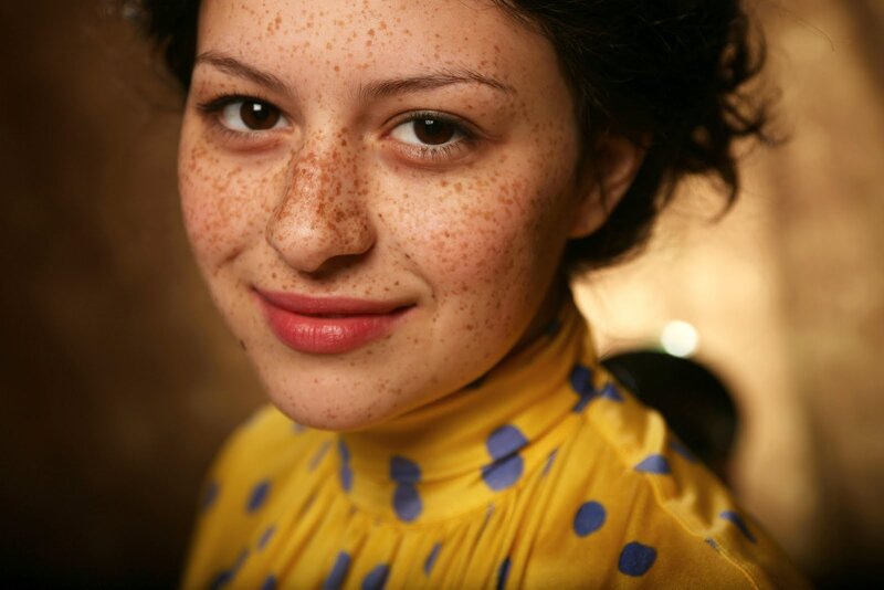 woman with freckles smiling