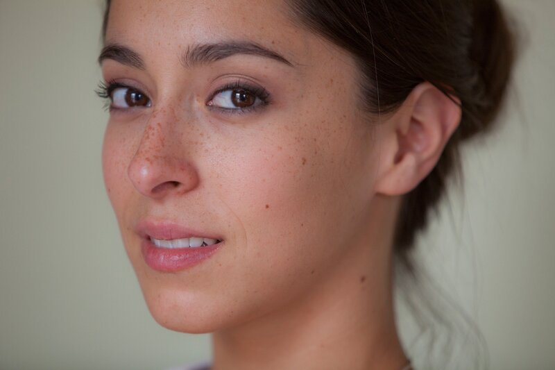 woman with freckles smiling