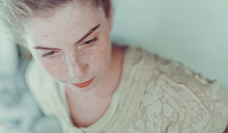 Woman with Freckles — White, Contemplative