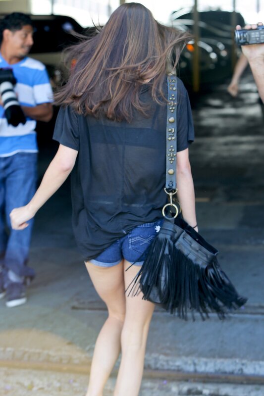 Woman with fringed bag walking