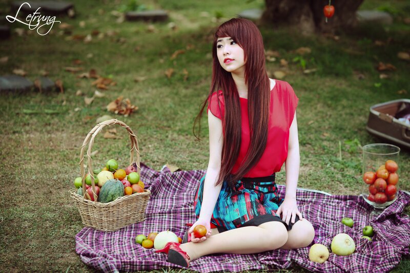 Woman with fruit basket in park