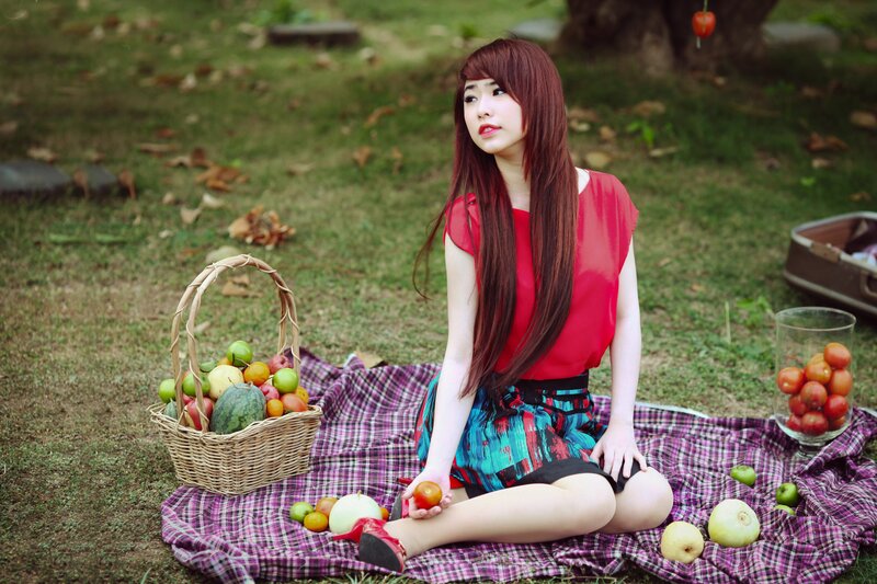 Woman with fruit basket in park