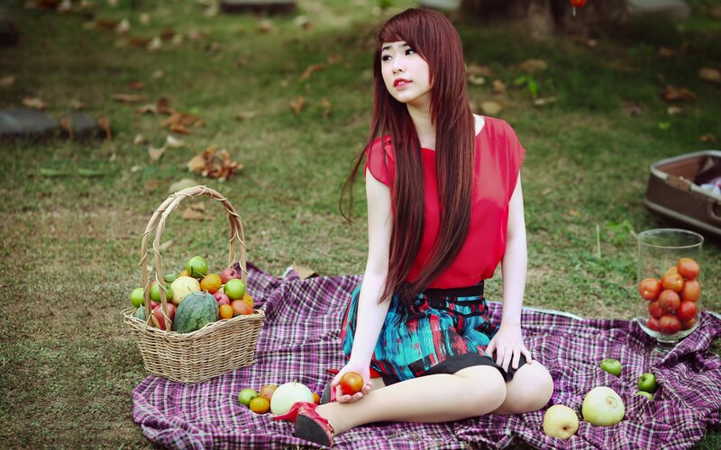Woman with fruit basket in park