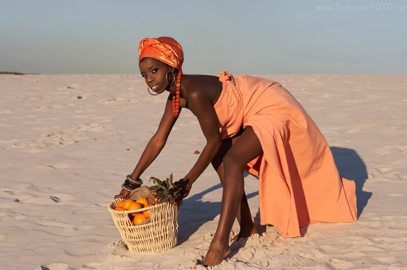 Woman with fruit basket on beach