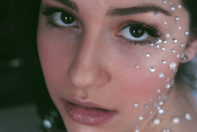 woman with gemstone face art