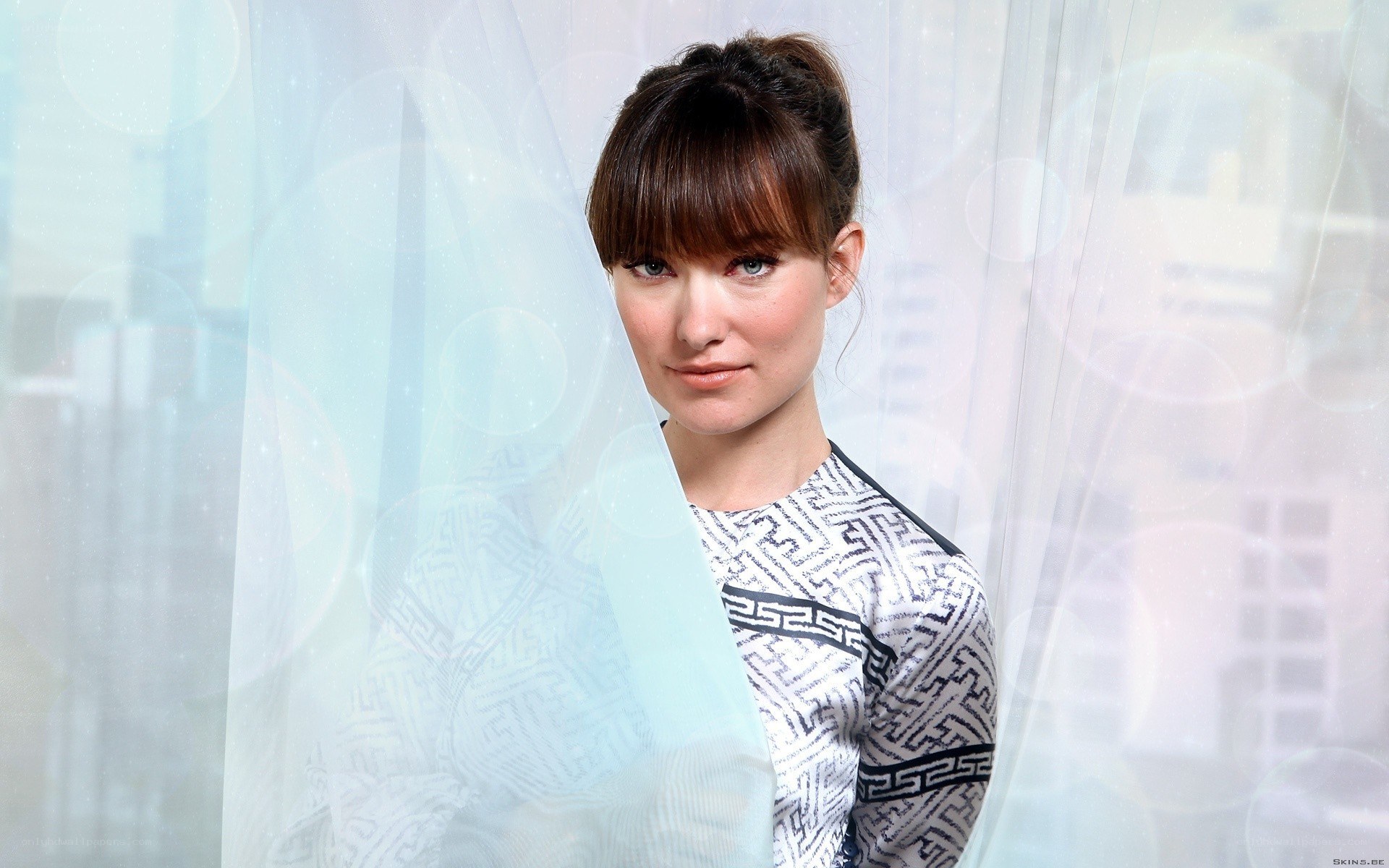 woman with geometric patterned top