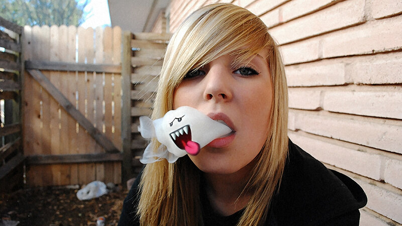 woman with ghost toy in mouth